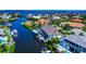 An aerial view of waterfront homes with private boat lifts and gorgeous landscaping along a canal at 4700 Mainsail Dr, Bradenton, FL 34208