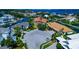 A wide angle aerial view of waterfront homes nestled in a cul-de-sac, surrounded by lush landscaping at 4700 Mainsail Dr, Bradenton, FL 34208
