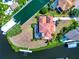 Aerial view of a luxurious home with a screened-in pool and boat dock on a waterfront property at 4700 Mainsail Dr, Bradenton, FL 34208