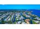 An expansive aerial view of waterfront properties with boat docks, nestled in a canal community with bay access at 4700 Mainsail Dr, Bradenton, FL 34208