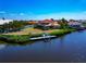 Stunning aerial view of waterfront property featuring a private dock and lush landscaping at 4700 Mainsail Dr, Bradenton, FL 34208