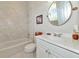 Bathroom with tiled shower and tub and vanity with custom mirror at 4700 Mainsail Dr, Bradenton, FL 34208