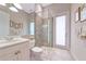 Modern bathroom with stand up shower, white vanity and tiled flooring at 4700 Mainsail Dr, Bradenton, FL 34208