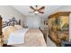 Bedroom showcasing a painted hutch, closet doors and iron bed at 4700 Mainsail Dr, Bradenton, FL 34208