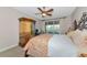 Bedroom with ceiling fan, painted hutch, iron bed, and balcony access at 4700 Mainsail Dr, Bradenton, FL 34208