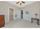 Bright bedroom featuring neutral walls, a ceiling fan, and an ensuite bathroom at 4700 Mainsail Dr, Bradenton, FL 34208
