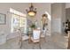 Bright dining room with a glass table, elegant chandelier, and staircase in view at 4700 Mainsail Dr, Bradenton, FL 34208