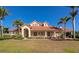 Stunning single-Gathering home with a tile roof, manicured lawn, and decorative columns at 4700 Mainsail Dr, Bradenton, FL 34208