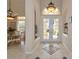 Grand foyer featuring tile flooring, high ceilings, and an open view of the dining area at 4700 Mainsail Dr, Bradenton, FL 34208