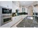 Modern kitchen features stainless steel appliances, granite countertops, and white cabinetry at 4700 Mainsail Dr, Bradenton, FL 34208