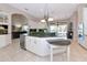 Modern kitchen with stainless steel appliances, a wine fridge, and island seating at 4700 Mainsail Dr, Bradenton, FL 34208