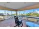 Screened lanai with comfortable seating offering peaceful water views, perfect for enjoying the outdoors at 4700 Mainsail Dr, Bradenton, FL 34208