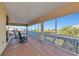 Spacious lanai with rocking chairs overlooking a serene waterway, offering a relaxing outdoor living space at 4700 Mainsail Dr, Bradenton, FL 34208