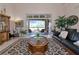 Living room with an area rug, furniture set, and sliding doors leading to the outdoor space at 4700 Mainsail Dr, Bradenton, FL 34208