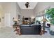 Open living room with soaring ceilings, a ceiling fan, and access to the outdoor patio at 4700 Mainsail Dr, Bradenton, FL 34208