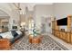 Spacious living room with high ceilings, elegant decor, and abundant natural light at 4700 Mainsail Dr, Bradenton, FL 34208