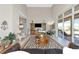 Spacious living room featuring high ceilings, a decorative rug, and sliding glass doors to the outdoor space at 4700 Mainsail Dr, Bradenton, FL 34208