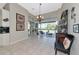 An open living room with a view to an outdoor seating area, natural light and tile flooring at 4700 Mainsail Dr, Bradenton, FL 34208