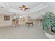 Spacious loft area with a tray ceiling, ceiling fan, and a view of the lower level, perfect for relaxing at 4700 Mainsail Dr, Bradenton, FL 34208