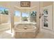 Corner bathtub with wrap around corner window overlooking the outdoors at 4700 Mainsail Dr, Bradenton, FL 34208