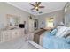 Spacious main bedroom featuring a ceiling fan and walk-in to the main bathroom at 4700 Mainsail Dr, Bradenton, FL 34208