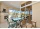 Covered outdoor patio with a dining area and fireplace, offering views of the yard at 4700 Mainsail Dr, Bradenton, FL 34208