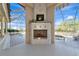 Covered patio with a fireplace overlooking the pool and spa at 4700 Mainsail Dr, Bradenton, FL 34208
