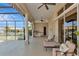 Spacious covered patio with outdoor kitchen and lounge area, perfect for entertaining at 4700 Mainsail Dr, Bradenton, FL 34208