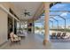 A spacious covered patio with a fireplace, seating, and views of the screened-in pool, perfect for relaxing at 4700 Mainsail Dr, Bradenton, FL 34208