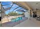 The covered outdoor space showcases a luxurious screened-in pool, ideal for entertaining and relaxing at 4700 Mainsail Dr, Bradenton, FL 34208