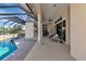 Inviting outdoor living space featuring a screened-in pool and covered patio with comfortable seating area at 4700 Mainsail Dr, Bradenton, FL 34208