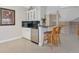 Loft wet bar equipped with modern appliances, a sink, and seating, ideal for entertaining guests at 4700 Mainsail Dr, Bradenton, FL 34208