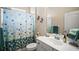 Bathroom featuring a vanity, mirror, and shower with a vibrant, polka-dot shower curtain at 4734 Claremont Park Dr, Bradenton, FL 34211