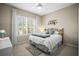 Comfortable bedroom featuring a ceiling fan, shutters, and a decorative headboard and wall art at 4734 Claremont Park Dr, Bradenton, FL 34211