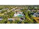 Aerial view of a community pool area surrounded by palm trees and lush landscaping at 4734 Claremont Park Dr, Bradenton, FL 34211