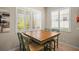 Dining room with a wooden table, four chairs, and plantation shutters at 4734 Claremont Park Dr, Bradenton, FL 34211