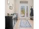 Inviting entryway with decorative glass door, stylish console table, and neutral tile flooring at 4734 Claremont Park Dr, Bradenton, FL 34211
