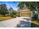 Beautiful single-Gathering home with a well-manicured lawn, mature trees, and a two-car garage at 4734 Claremont Park Dr, Bradenton, FL 34211