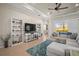 Inviting living room with custom built-in shelves, a comfortable sofa, and bright natural light at 4734 Claremont Park Dr, Bradenton, FL 34211