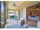 Cozy screened-in patio with comfortable seating, ceiling fan, and sliding door to the home's interior at 4734 Claremont Park Dr, Bradenton, FL 34211