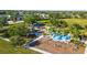 A vibrant playground area with swings, slides, and ample space for to play and enjoy the outdoors at 4734 Claremont Park Dr, Bradenton, FL 34211