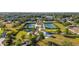 Aerial view of community tennis courts and recreation area surrounded by mature trees and lush landscaping at 4734 Claremont Park Dr, Bradenton, FL 34211