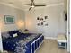 Cozy bedroom with stylish blue bedding, neutral walls, a ceiling fan, and bright, natural light at 48 Lark Dr, Placida, FL 33946