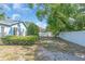 Charming blue home with landscaped backyard and white privacy fence at 5012 Eastchester Dr, Sarasota, FL 34234