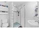 Bathroom with a glass block shower, sink and toilet at 5012 Eastchester Dr, Sarasota, FL 34234