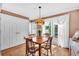 Charming dining area featuring hardwood floors and a vintage fruit-themed chandelier at 5012 Eastchester Dr, Sarasota, FL 34234