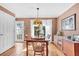 Bright dining room with hardwood floors, vintage lighting, and a view to the backyard at 5012 Eastchester Dr, Sarasota, FL 34234
