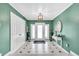 Inviting foyer with a unique tiled floor, green walls, and a decorative light fixture at 5012 Eastchester Dr, Sarasota, FL 34234