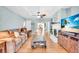 Spacious living room featuring wood floors, fireplace and an open concept design with views to the dining area at 5012 Eastchester Dr, Sarasota, FL 34234