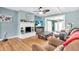Comfortable living room with a white brick fireplace and open view to the entry and dining area at 5012 Eastchester Dr, Sarasota, FL 34234